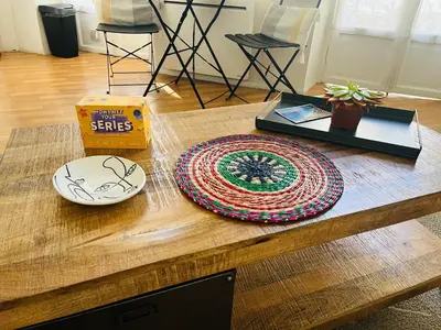 a wooden table with a book and a plate on it at Charmant studio en plein coeur de Nice in Nice