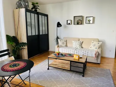 a living room with a couch and a table at Charmant studio en plein coeur de Nice in Nice