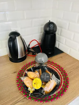 a plate of food on a table with a tea kettle at Charmant studio en plein coeur de Nice in Nice