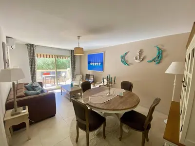 a living room with a table and a couch at Nice Ouest 2P Sea view, Pool, Quiet in Nice