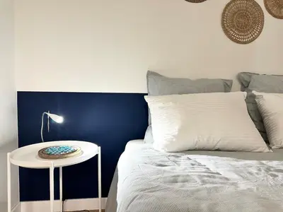 a bed with a nightstand next to a white bed at Rivoli- Quiet apartment, close to Negresco in Nice