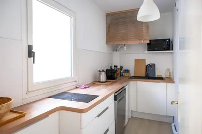 a kitchen with white cabinets and a counter top at Rivoli- Quiet apartment, close to Negresco in Nice