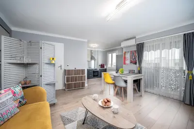 a living room with a couch and a table at Cozy Appartement close to Port of Nice in Nice