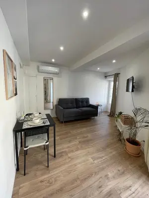 a living room with a couch and a table at Joli Studio Place Garibaldi, Vieux-Nice, Port in Nice