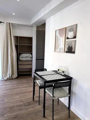 a dining room with a black table and chairs at Joli Studio Place Garibaldi, Vieux-Nice, Port in Nice