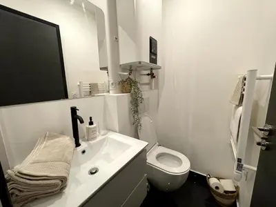 a white bathroom with a sink and a toilet at Joli Studio Place Garibaldi, Vieux-Nice, Port in Nice