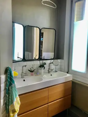 a bathroom with two sinks and two mirrors at Beau 3 pièces Libération Nice in Nice