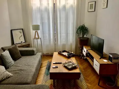 a living room with a couch and a coffee table at Beau 3 pièces Libération Nice in Nice