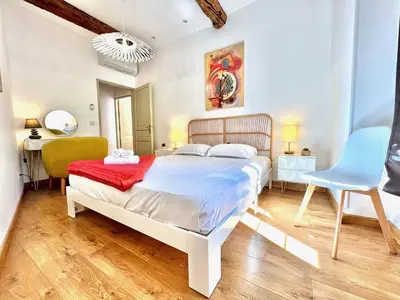 a bedroom with a white bed and a blue chair at ApartHotel Riviera - La Maison De Francois - Old Town in Nice