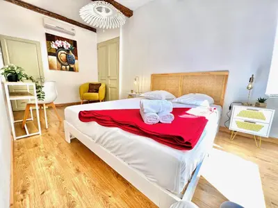 a bedroom with a large white bed with towels on it at ApartHotel Riviera - La Maison De Francois - Old Town in Nice