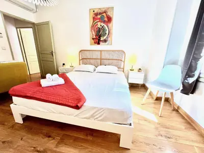 a bedroom with a bed and a blue chair at ApartHotel Riviera - La Maison De Francois - Old Town in Nice