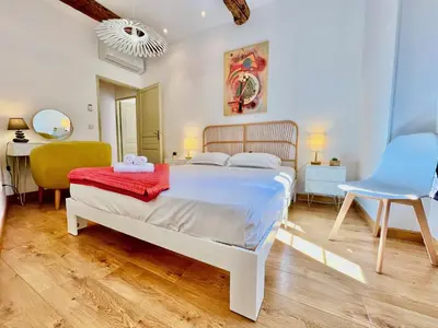 a bedroom with a bed and a desk and a chair at ApartHotel Riviera - La Maison De Francois - Old Town in Nice