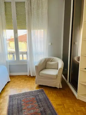 a white chair in a room with a window at Pleasant central apartment with balcony in Nice