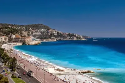 a view of a beach with people and the ocean at Pleasant central apartment with balcony in Nice