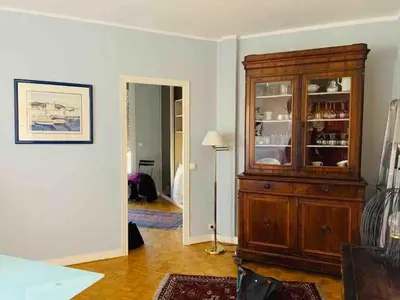 a living room with a large wooden hutch at Pleasant central apartment with balcony in Nice