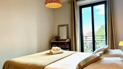 a bedroom with a bed with a teddy bear on it at ApartHotel Riviera - Terrasse Felix Faure 2 - Massena in Nice