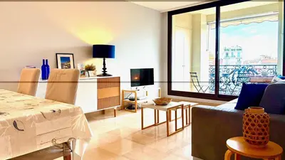 a living room with a couch and a table with a view at ApartHotel Riviera - Terrasse Felix Faure 2 - Massena in Nice