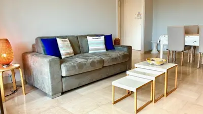 a living room with a couch and a table at ApartHotel Riviera - Terrasse Felix Faure 2 - Massena in Nice