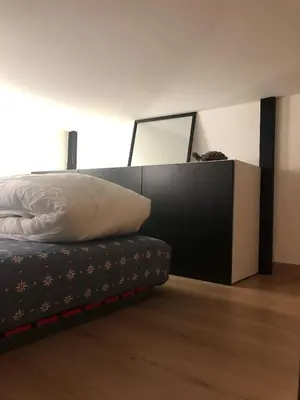 a bedroom with a bed with a pillow and a mirror at Lovely cozy studio in Nice