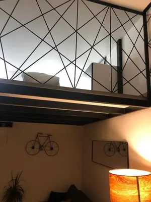 a room with a ceiling with a bike on it at Lovely cozy studio in Nice