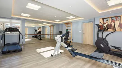 a gym with treadmills and ellipticals in a room at Quality Aparthotel Nice in Nice