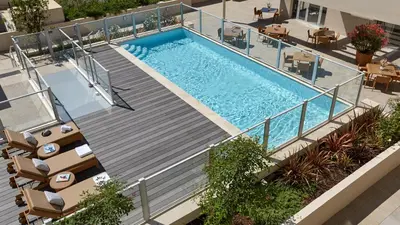 an overhead view of a swimming pool in a building at Quality Aparthotel Nice in Nice