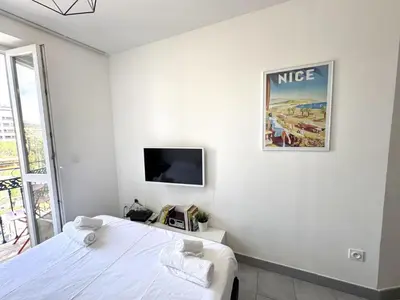 a bedroom with a bed and a tv on the wall at ApartHotel riviera - Balcon Jean Jaures 2 - Place Massena - Old in Nice