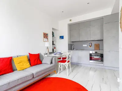 a living room with a couch and a kitchen at Apartment Le Palais du Vieux Port by Interhome in Nice