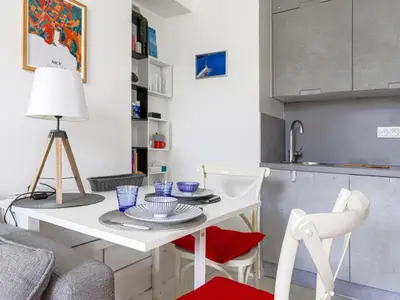 a small kitchen with a white table and chairs at Apartment Le Palais du Vieux Port by Interhome in Nice