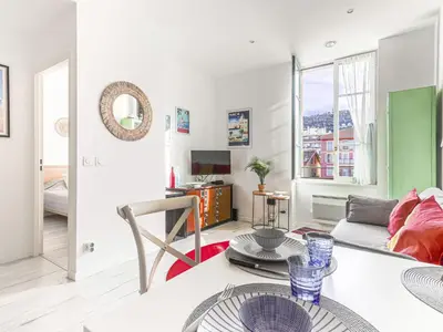 a bedroom with a large bed and a large window at Apartment Le Palais du Vieux Port by Interhome in Nice
