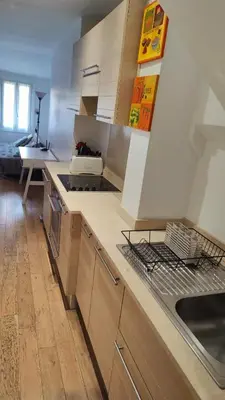 a kitchen with wooden cabinets and a counter top at Beach Proximity in Historic Nice, Your Perfect 2 Room Rental in Nice