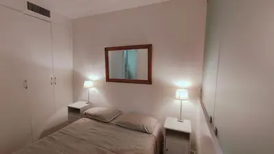 a bedroom with a bed and two tables with lamps at Beach Proximity in Historic Nice, Your Perfect 2 Room Rental in Nice