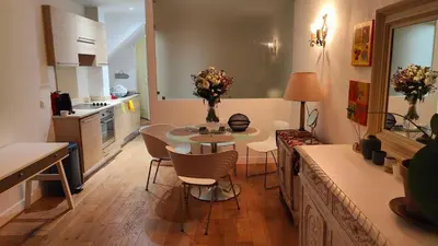 a kitchen with a table and chairs in a kitchen at Beach Proximity in Historic Nice, Your Perfect 2 Room Rental in Nice