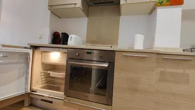 an empty kitchen with an oven and a refrigerator at Beach Proximity in Historic Nice, Your Perfect 2 Room Rental in Nice