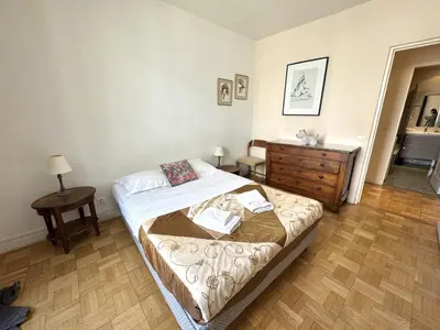 a bedroom with a bed and a dresser in it at ApartHotel Riviera - Hotel des Postes 2 - City center Massena in Nice