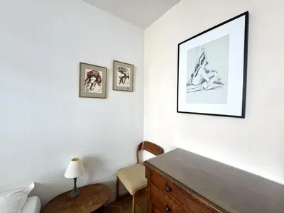 a bedroom with a dresser and a picture on the wall at ApartHotel Riviera - Hotel des Postes 2 - City center Massena in Nice