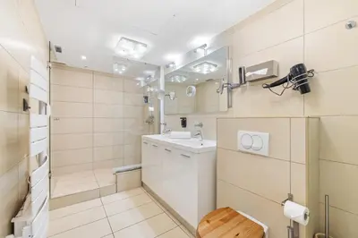 a bathroom with a toilet and a sink and a mirror at Appartement de la Colline - Welkeys in Nice