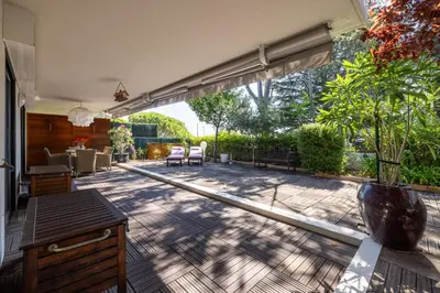 an open patio with a table and chairs at Appartement de la Colline - Welkeys in Nice
