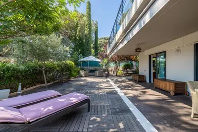 a patio with a purple couch on the side of a building at Appartement de la Colline - Welkeys in Nice