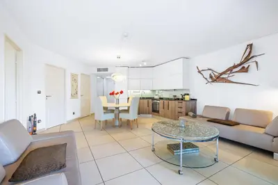 a living room with a couch and a table at Appartement de la Colline - Welkeys in Nice
