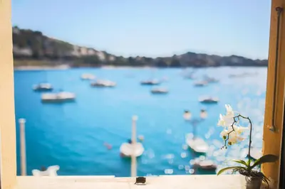 a window with a view of a harbor with boats at MARINE AP4445 By Riviera Holiday Homes in Villefranche-sur-Mer