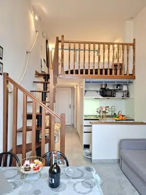 a kitchen and a living room with a table and a kitchen at MARINE AP4445 By Riviera Holiday Homes in Villefranche-sur-Mer