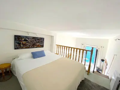 a bedroom with a bed with a blue pillow on it at MARINE AP4445 By Riviera Holiday Homes in Villefranche-sur-Mer