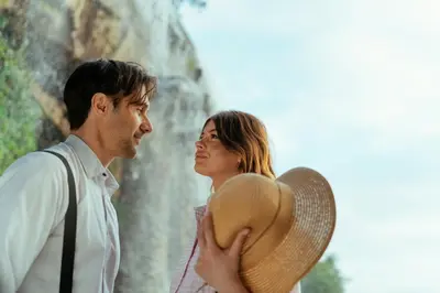 a man and a woman standing in front of a waterfall at Azur BnB in Nice