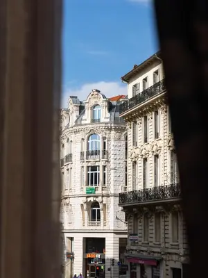 a large white building on a city street at Azur BnB in Nice