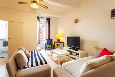 a living room with a couch and a tv at ESCALINADA II AP4433 by Riviera Holiday Homes in Villefranche-sur-Mer