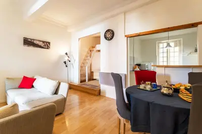 a living room with a table and a couch at ESCALINADA II AP4433 by Riviera Holiday Homes in Villefranche-sur-Mer