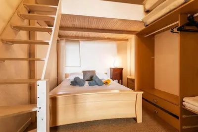 a bedroom with a bunk bed and a ladder at ESCALINADA II AP4433 by Riviera Holiday Homes in Villefranche-sur-Mer