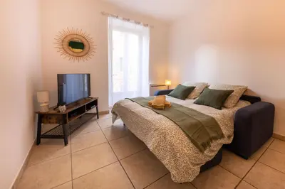 a bedroom with a bed and a flat screen tv at Joli cocon à 3 min à pied de la mer in Nice