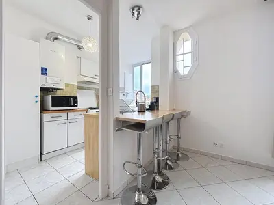 a kitchen with white cabinets and a counter top at Nice Carlone Appart 6 pers, Clim, proche mer, transports in Nice
